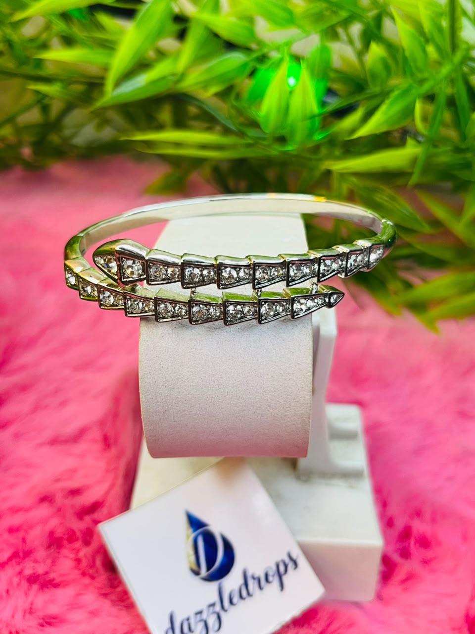 Set of silver-toned crystal cuff bracelets featuring snake, tiara, and floral designs displayed in a white DazzleDrops box. — view 2