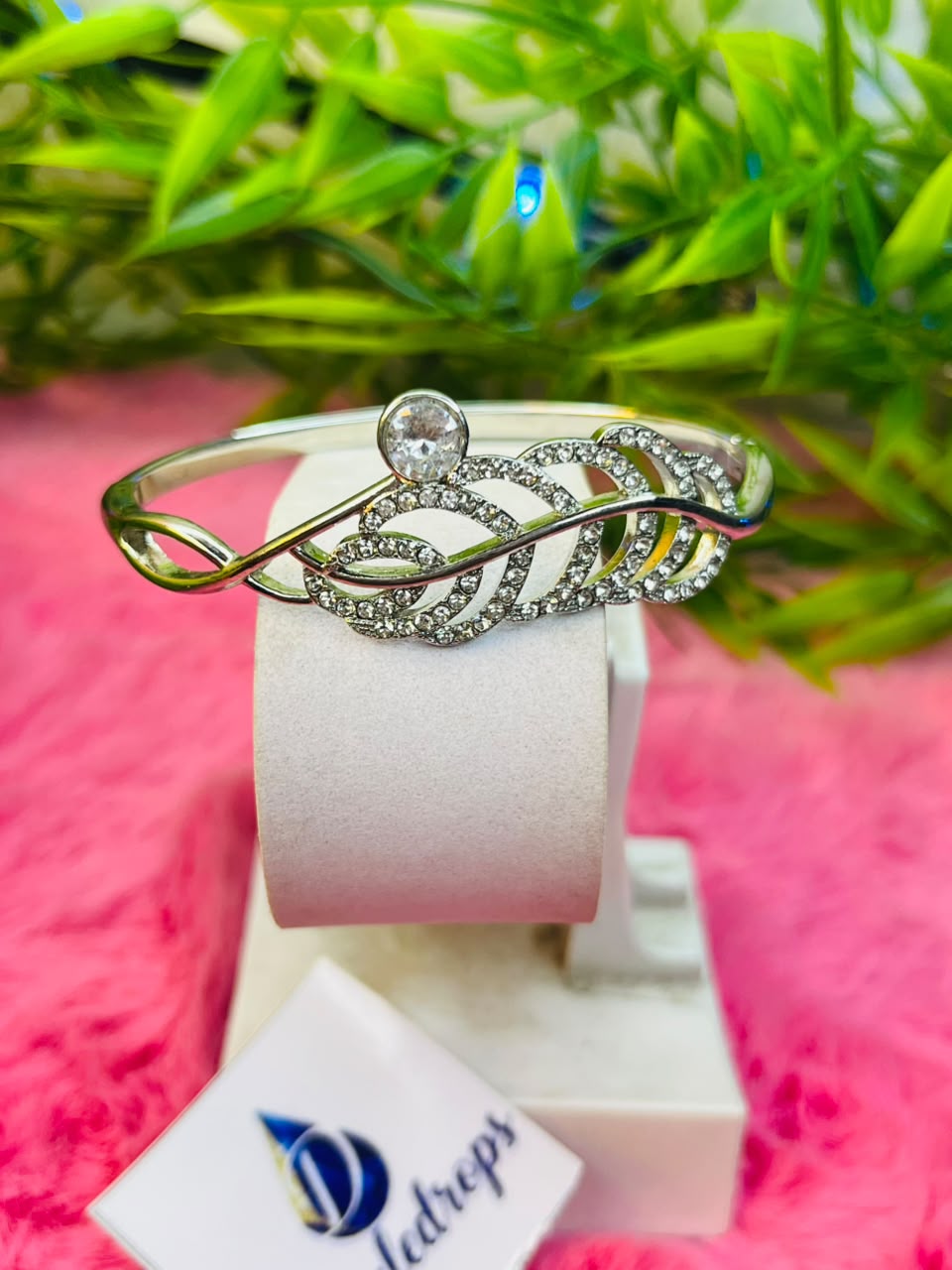 Set of silver-toned crystal cuff bracelets featuring snake, tiara, and floral designs displayed in a white DazzleDrops box.