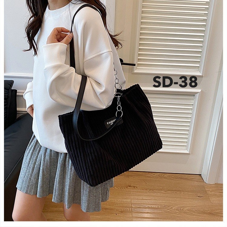 Woman wearing white sweatshirt carrying Korean black corduroy shoulder tote bag